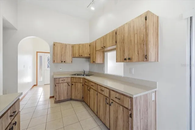 a kitchen that has a sink and a stove in it