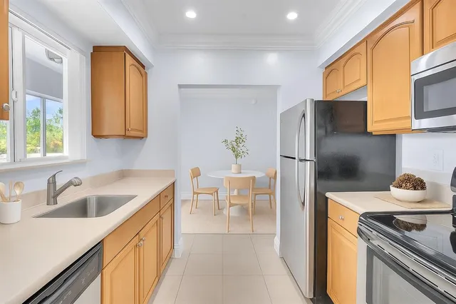 a kitchen that has a sink and a refrigerator