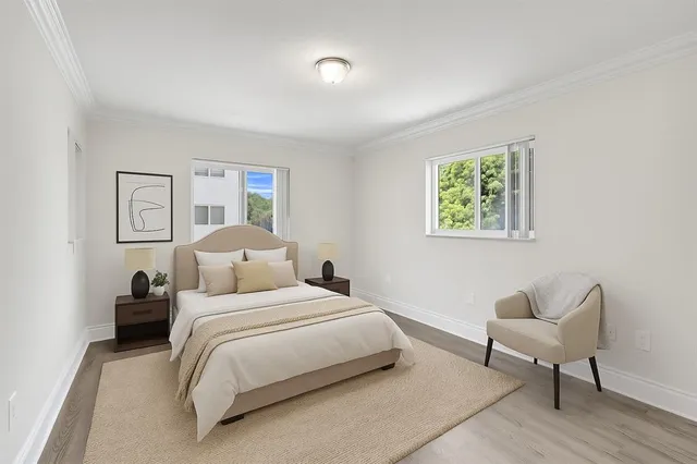 a bedroom with a bed and a chair