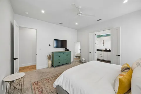 a bedroom with a bed and a television