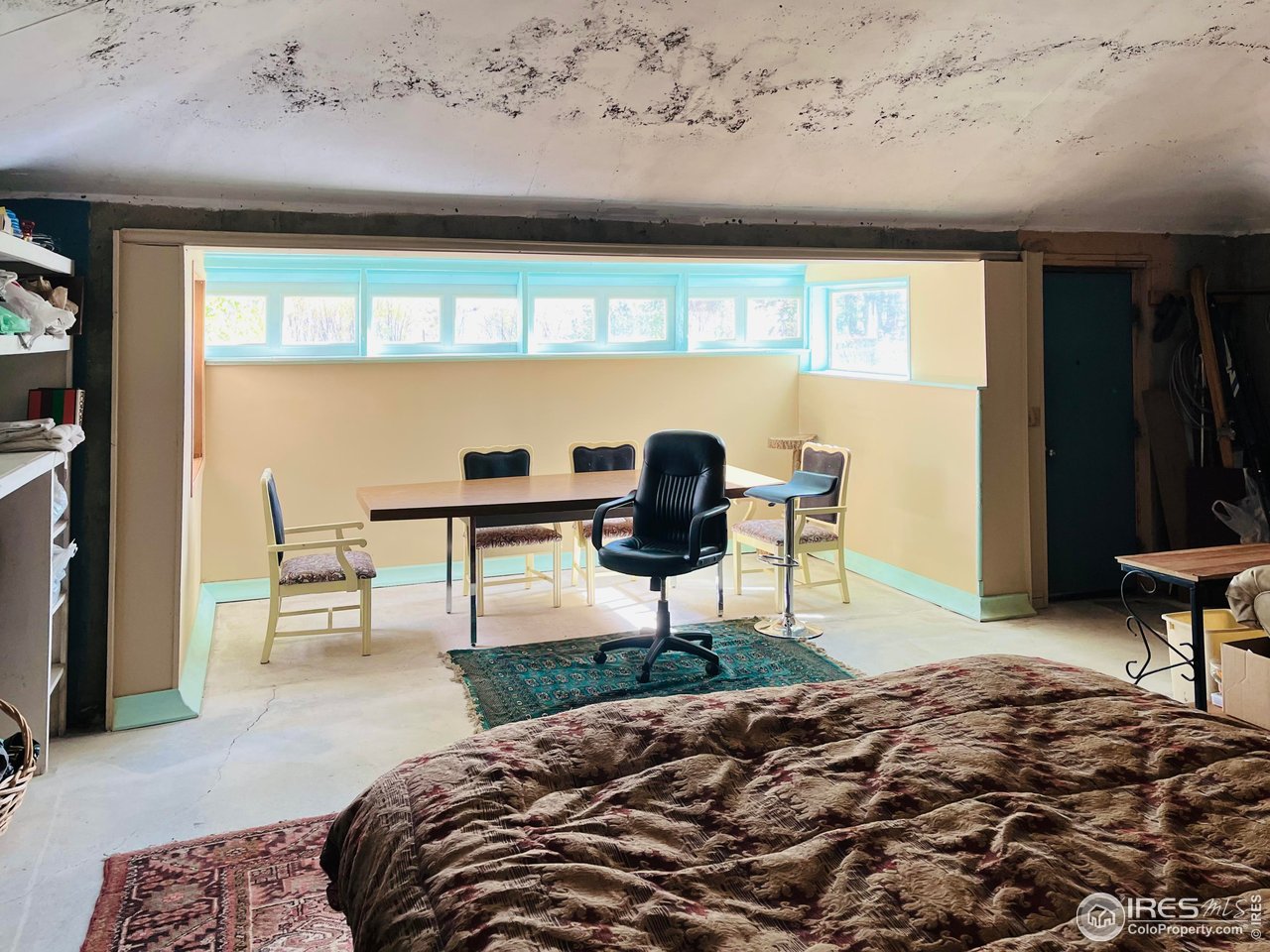 55999 Highway 318 Maybell, CO 81640 - Photo 16 of 50 a bedroom with a bed a table and chair