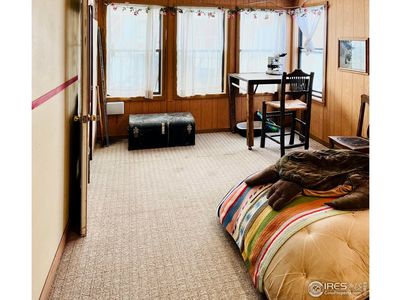 55999 Highway 318 Maybell, CO 81640 - Photo 19 of 50 a bedroom with a bed and large windows