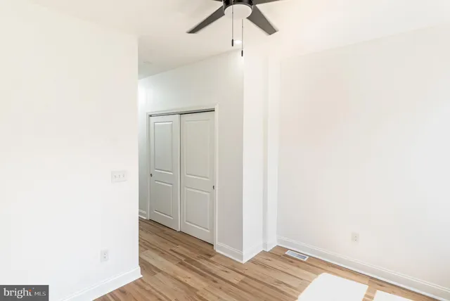 a view of a room with wooden floor