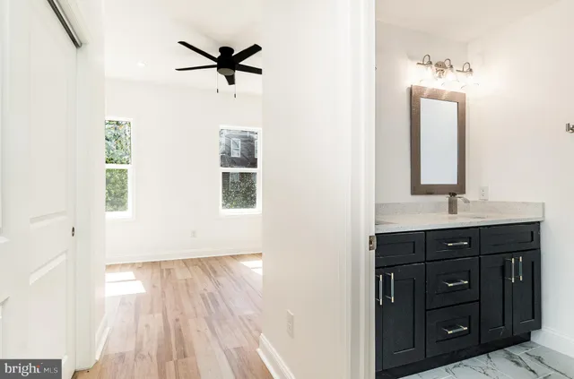 a bathroom with a sink a mirror and a shower