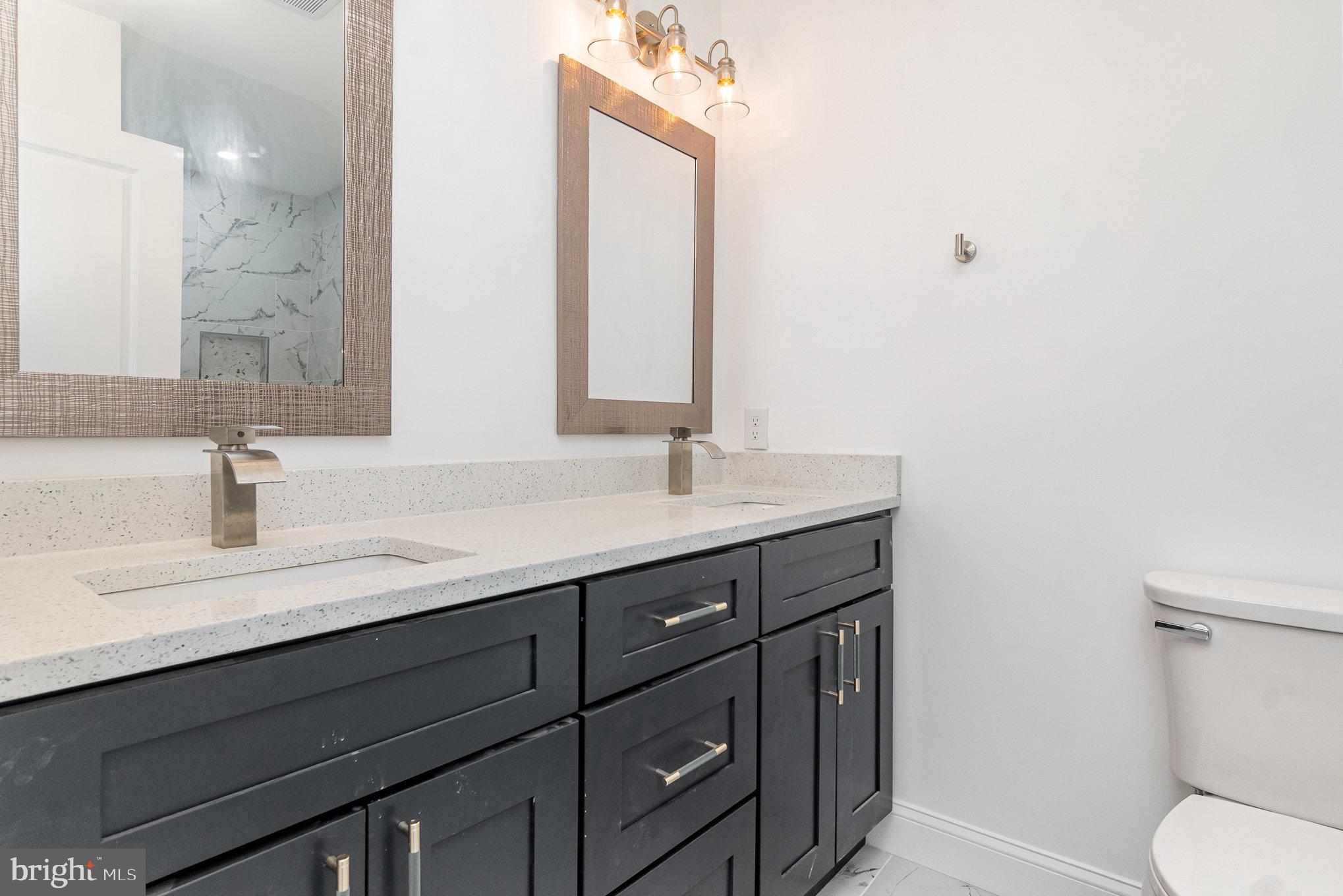 727 North Collington Avenue Baltimore, MD 21205 - Photo 13 of 25 a bathroom with a sink a toilet and mirror