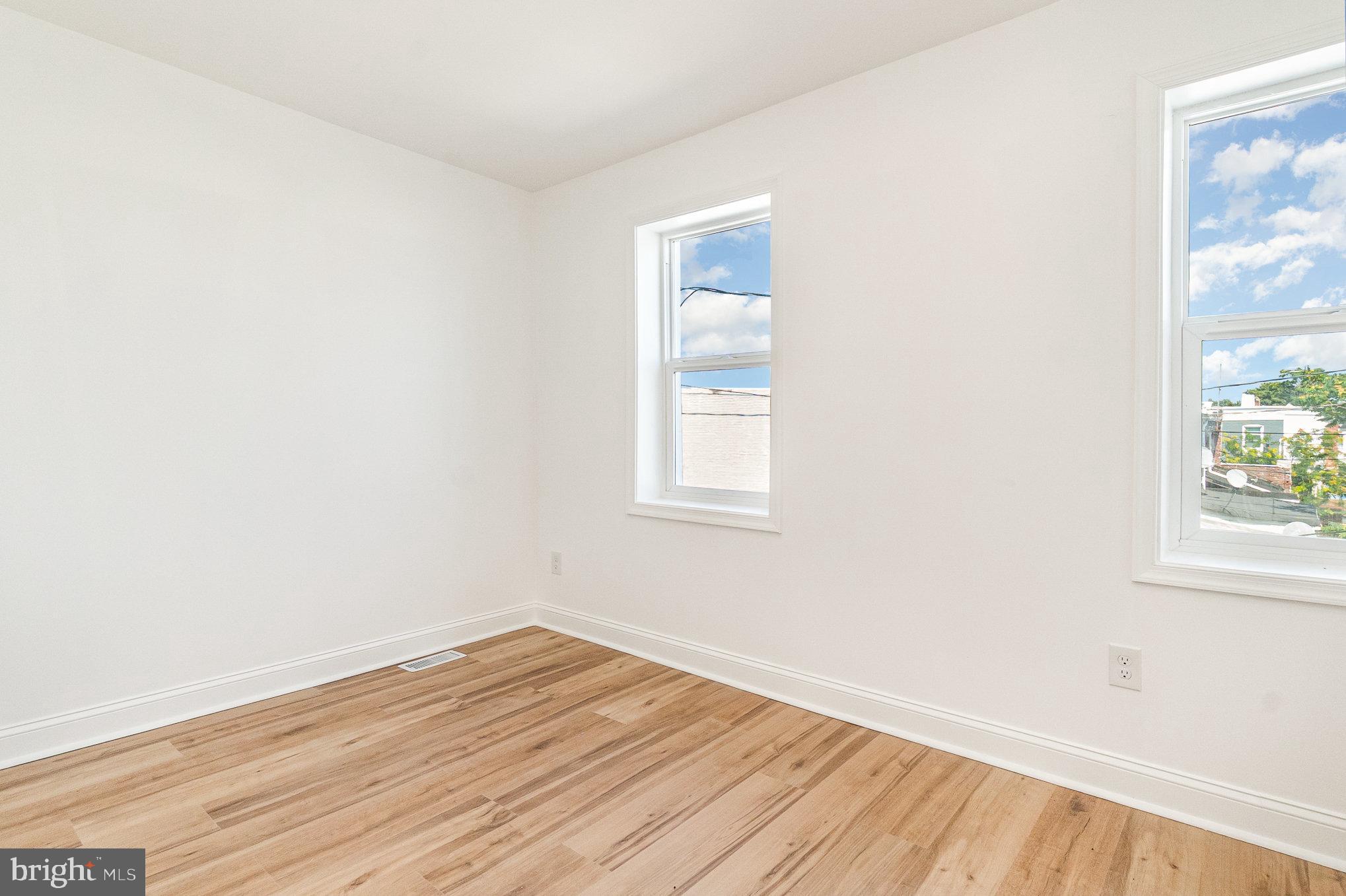 727 North Collington Avenue Baltimore, MD 21205 - Photo 15 of 25 an empty room with wooden floor and windows