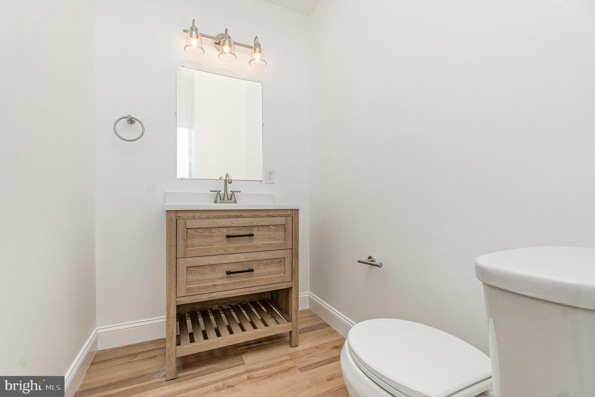 727 North Collington Avenue Baltimore, MD 21205 - Photo 17 of 25 a bathroom with a sink a toilet and mirror