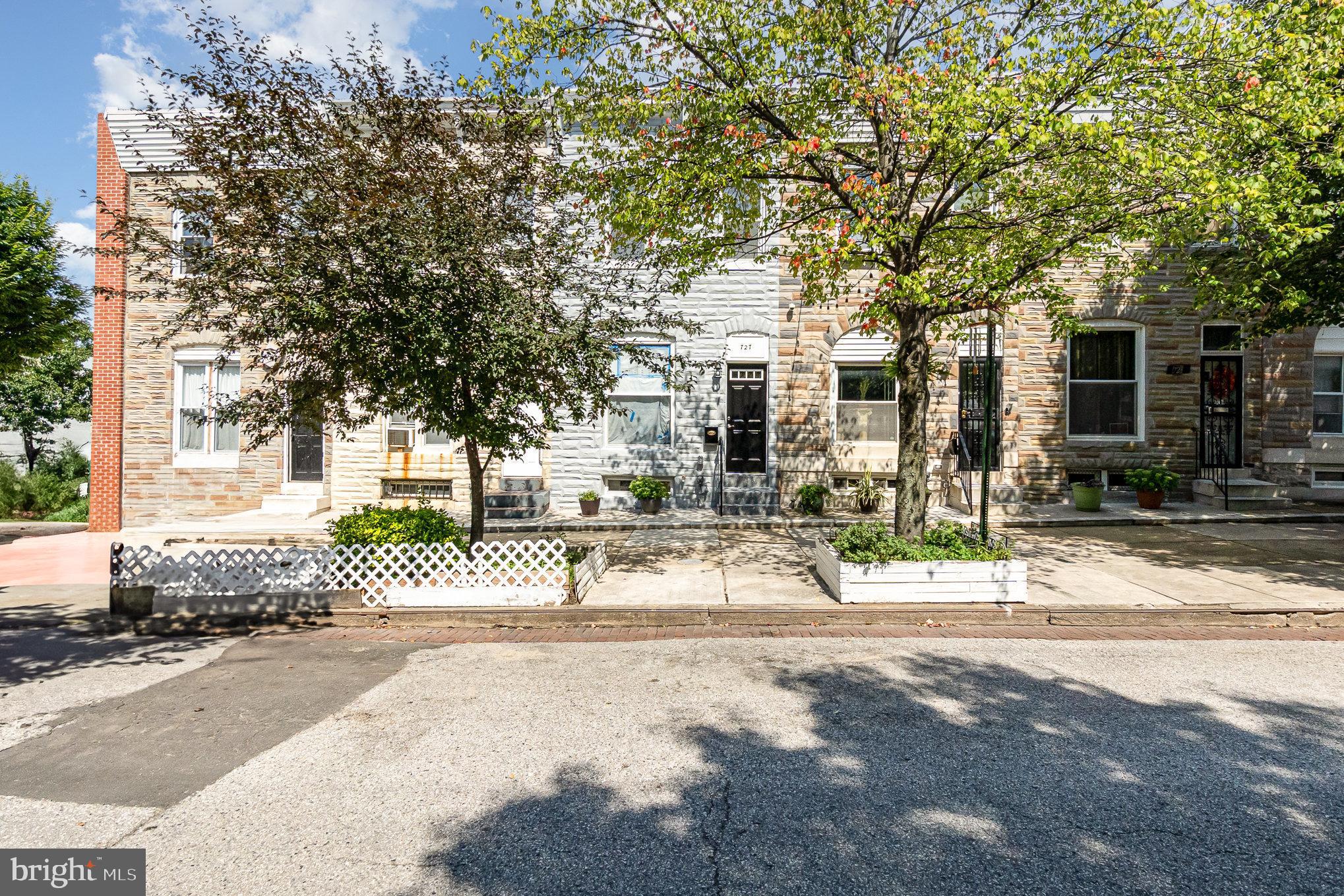 727 North Collington Avenue Baltimore, MD 21205 - Photo 2 of 25 a front view of a house with a garden and tree