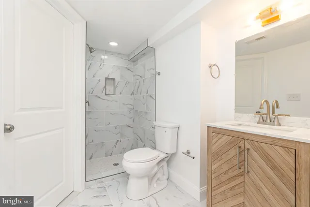 a bathroom with a toilet sink and shower