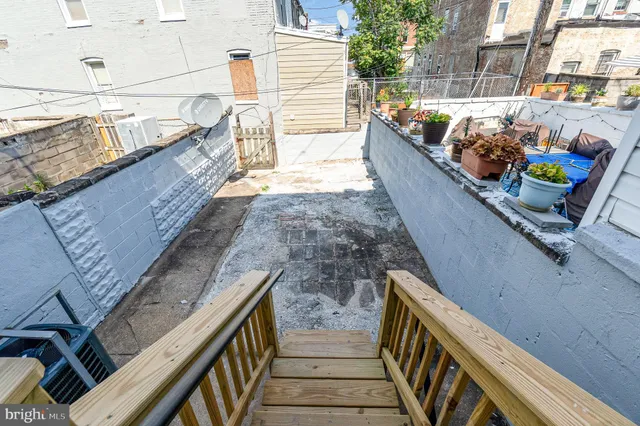 a balcony with two chairs and a table