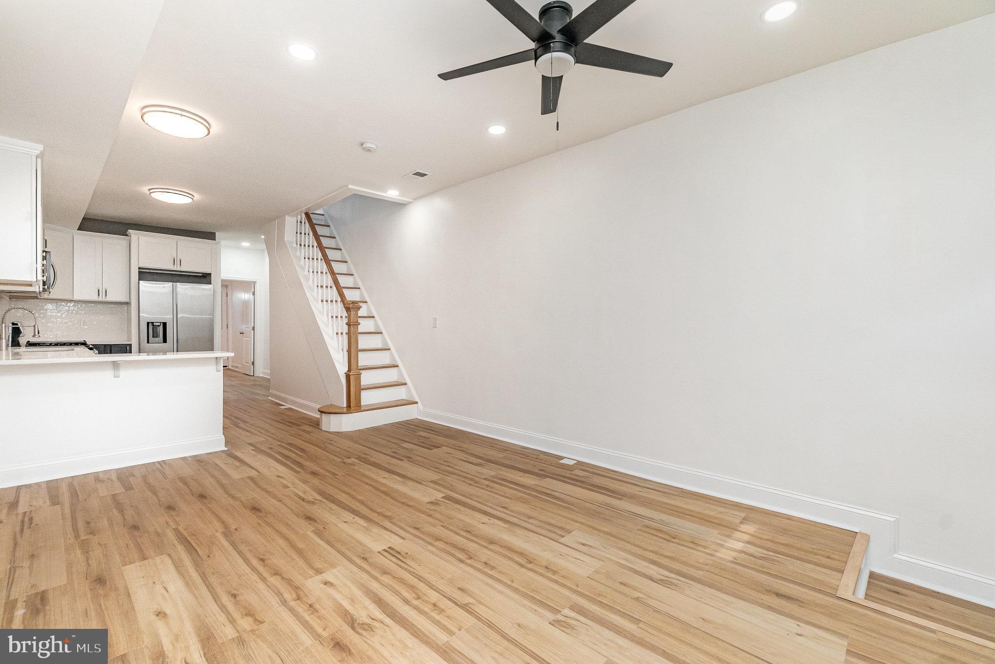 727 North Collington Avenue Baltimore, MD 21205 - Photo 4 of 25 a view of an empty room with wooden floor and a ceiling fan