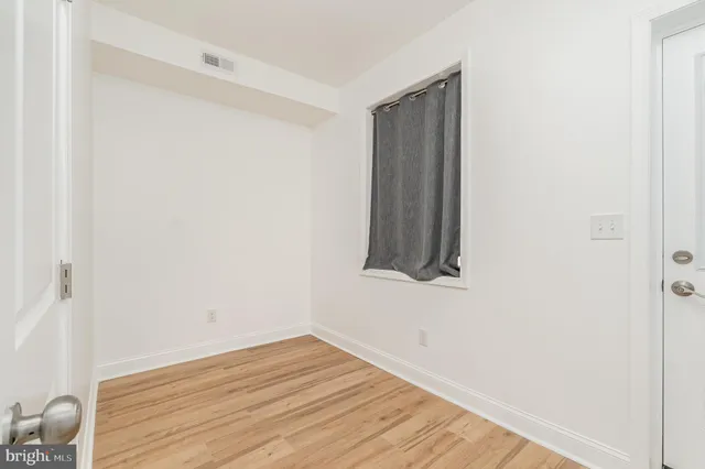 a view of a room with wooden floor and small space