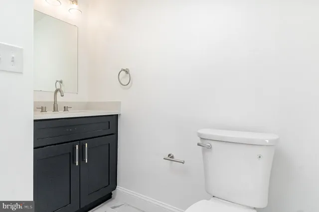a bathroom with a sink toilet and vanity
