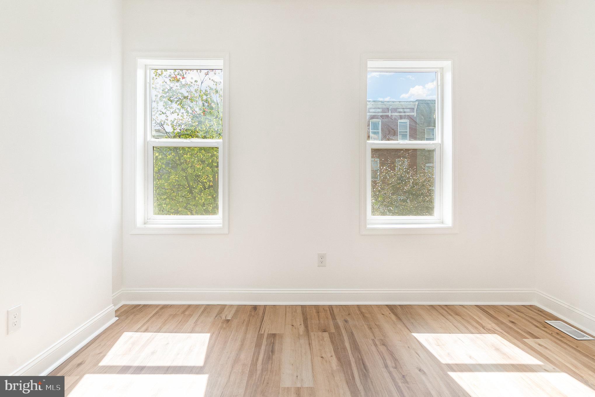 727 North Collington Avenue Baltimore, MD 21205 - Photo 10 of 25 an empty room with wooden floor and windows