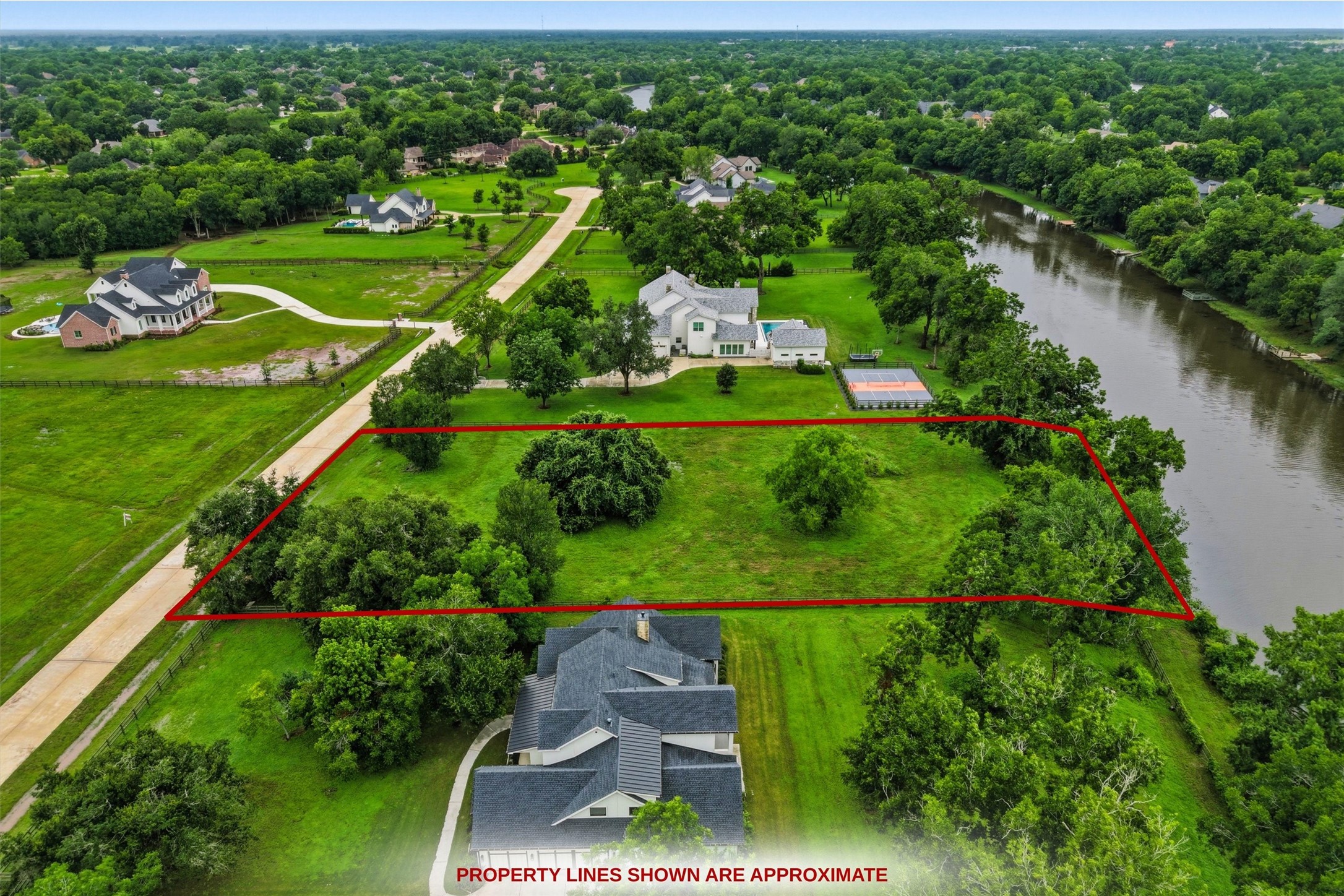 0 Riverlake Road Fulshear, TX 77441 - Photo 7 of 47 This breathtaking aerial perspective highlights the property's coveted riverfront location and remarkable setting among elegant custom estates.