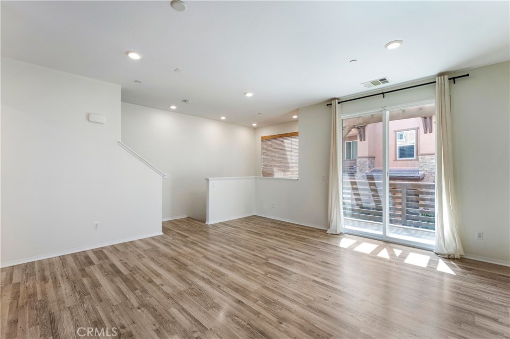 2890 Silver Medal Road, Unit 9 Chula Vista, CA 91915 - Photo 8 of 31 Family Room looking to door to balcony and stairs
*Photos have been digitallyenhanced