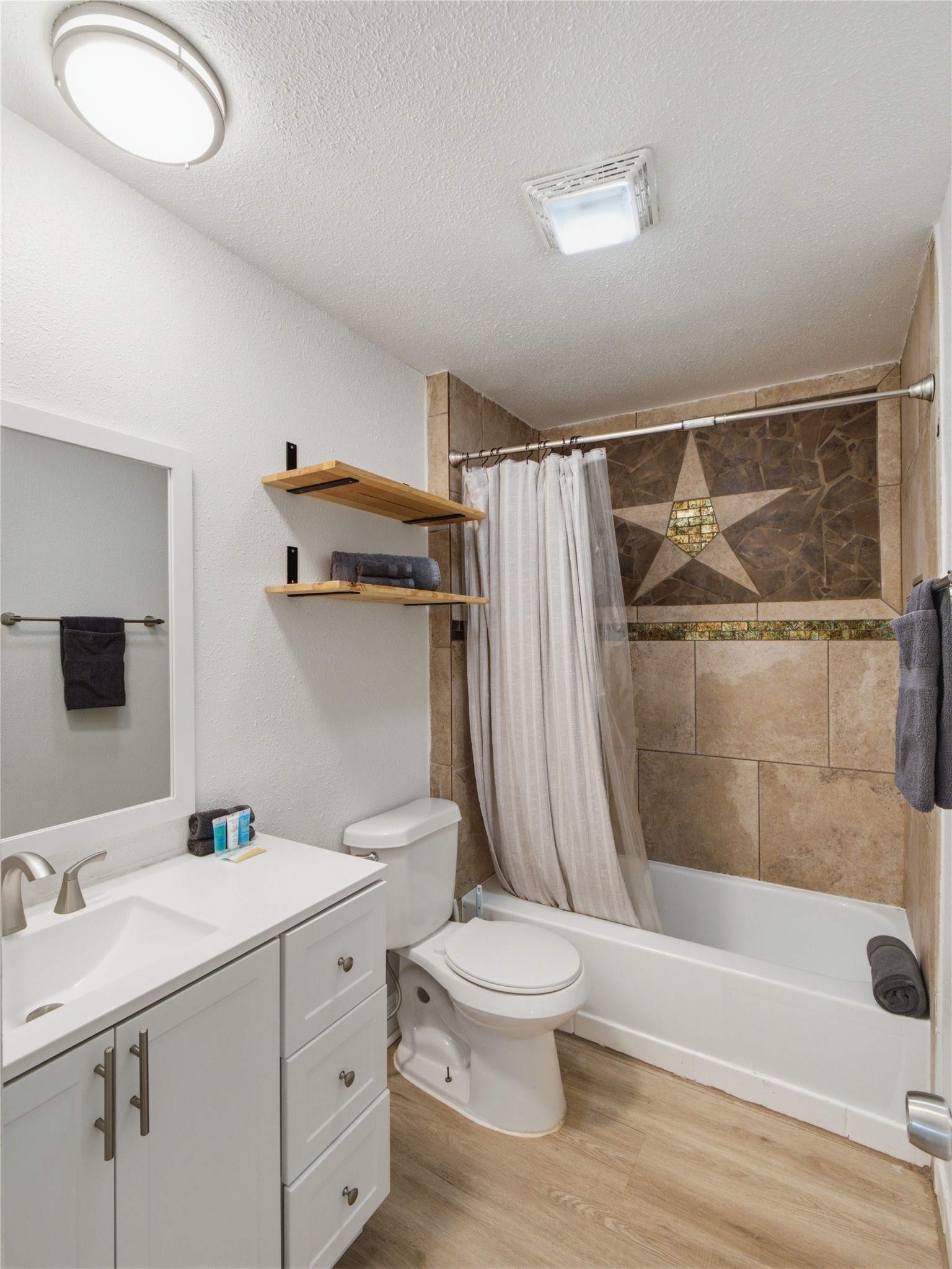 1108 Jolena Circle Austin, TX 78721 - Photo 9 of 21 A well-appointed bath with striking tilework surrounding the shower and tub.