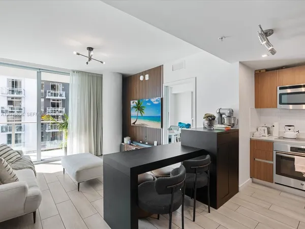 a kitchen with a table chairs stove and cabinets