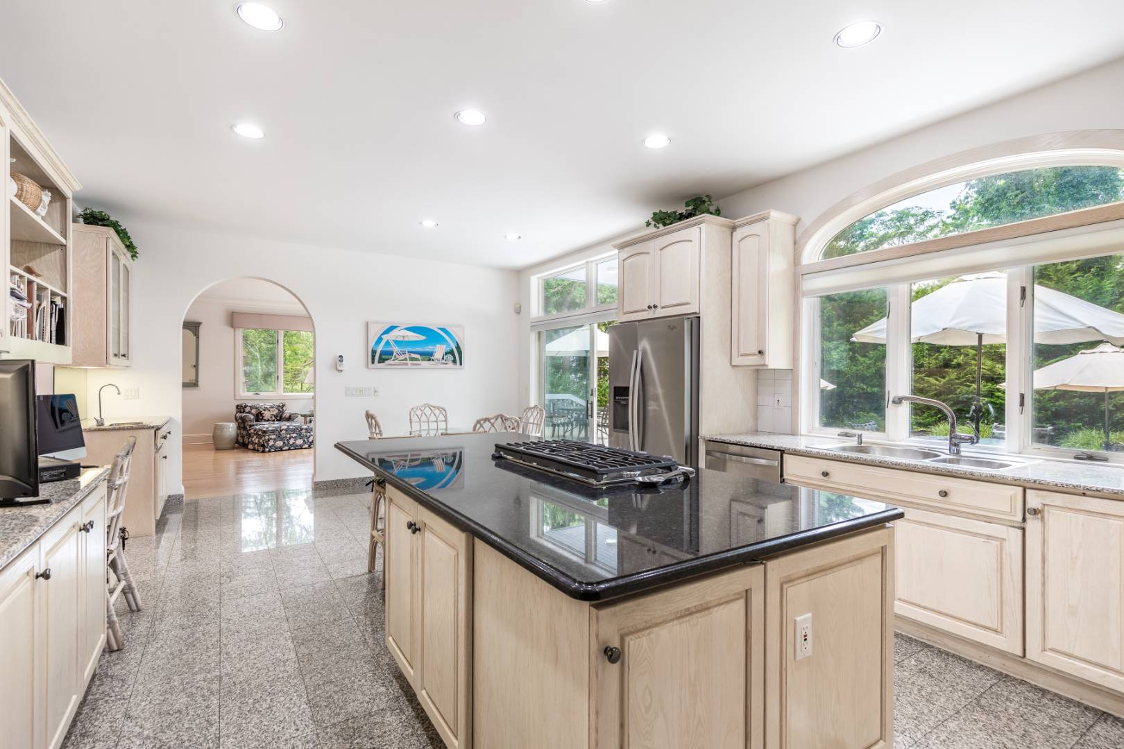 15 Atterbury Road Southampton, NY 11968 - Photo 11 of 20 a kitchen with stainless steel appliances granite countertop a sink stove and cabinets