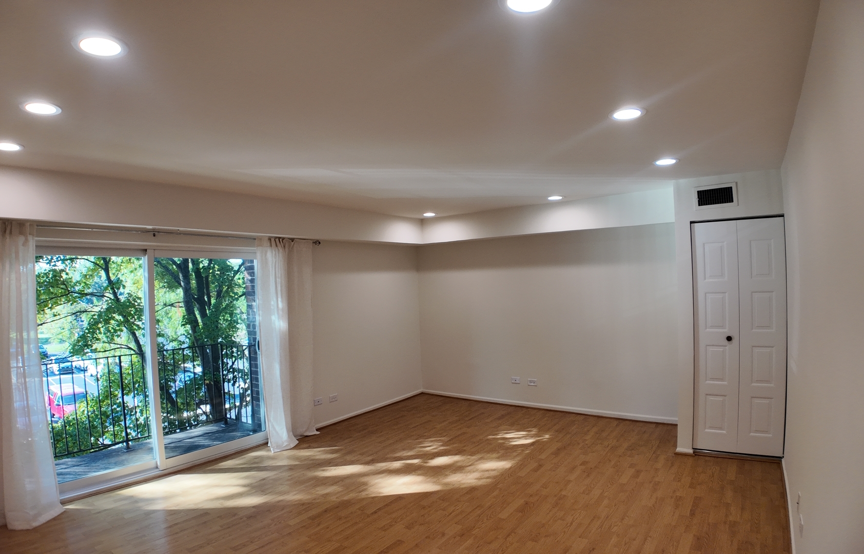 1450 Sandpebble Drive, Unit 333 Wheeling, IL 60090 - Photo 7 of 22 an empty room with wooden floor and windows