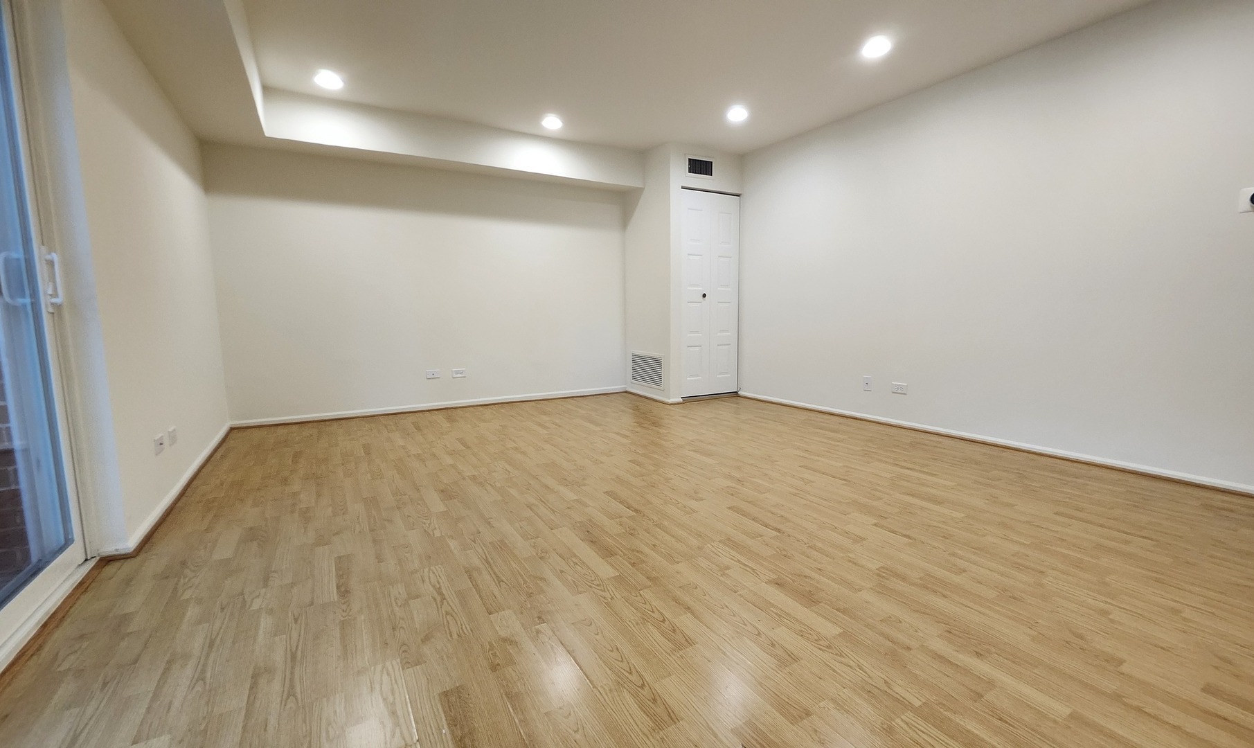 1450 Sandpebble Drive, Unit 333 Wheeling, IL 60090 - Photo 8 of 22 an empty room with wooden floor and windows