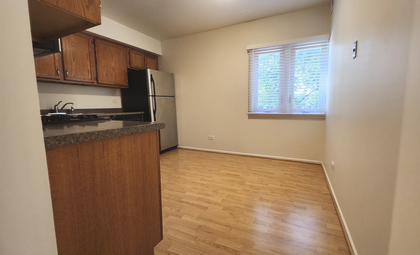 1450 Sandpebble Drive, Unit 333 Wheeling, IL 60090 - Photo 10 of 22 a kitchen with granite countertop cabinets stainless steel appliances a sink and a window