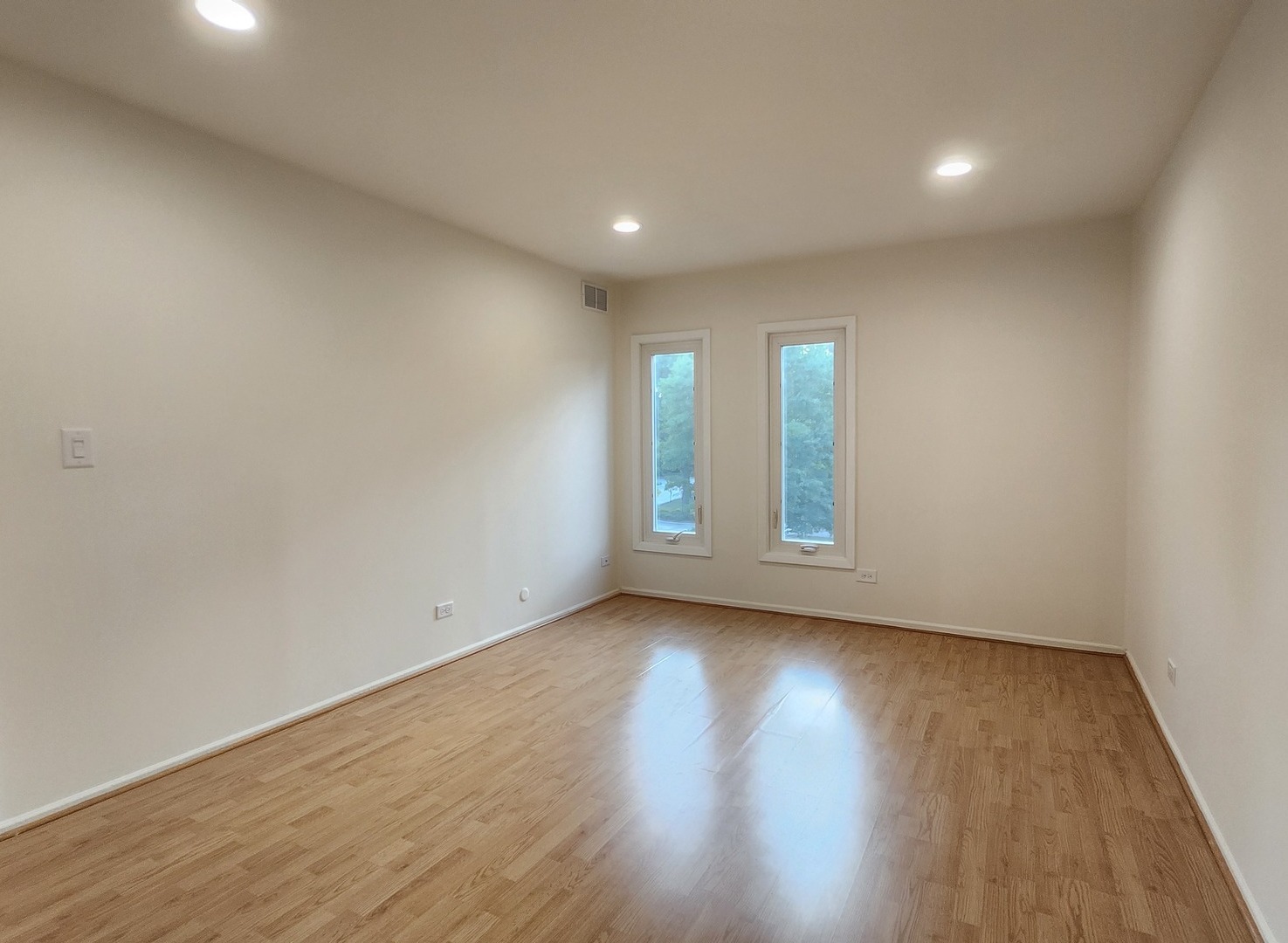 1450 Sandpebble Drive, Unit 333 Wheeling, IL 60090 - Photo 13 of 22 a view of an empty room with wooden floor and window