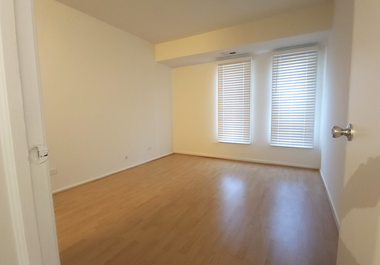 1450 Sandpebble Drive, Unit 333 Wheeling, IL 60090 - Photo 19 of 22 an empty room with wooden floor and windows