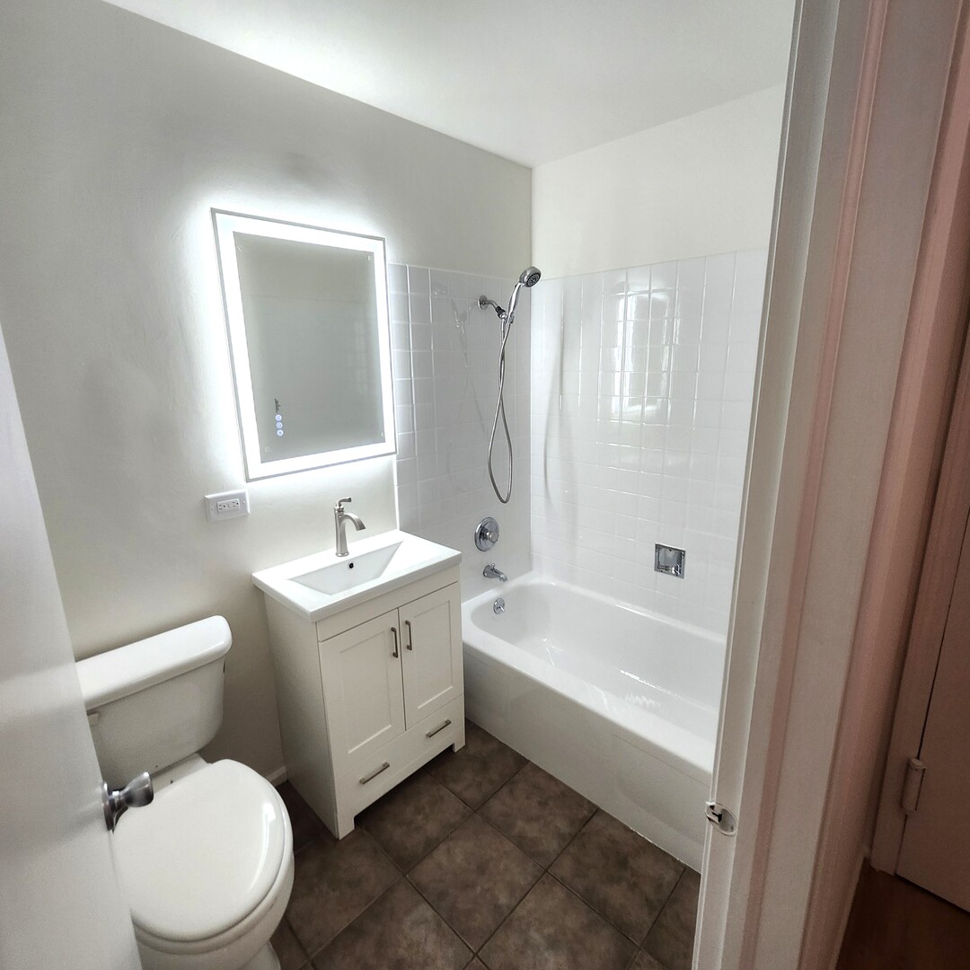 1450 Sandpebble Drive, Unit 333 Wheeling, IL 60090 - Photo 21 of 22 a bathroom with a sink a toilet and shower