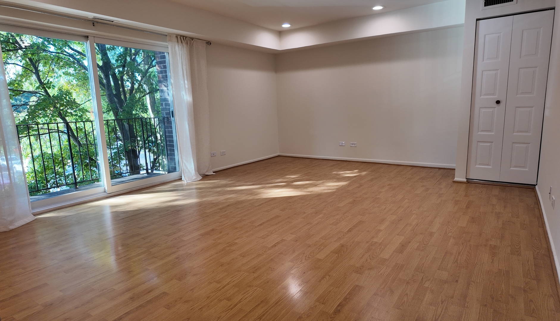 1450 Sandpebble Drive, Unit 333 Wheeling, IL 60090 - Photo 6 of 22 a view of an empty room with wooden floor and a window