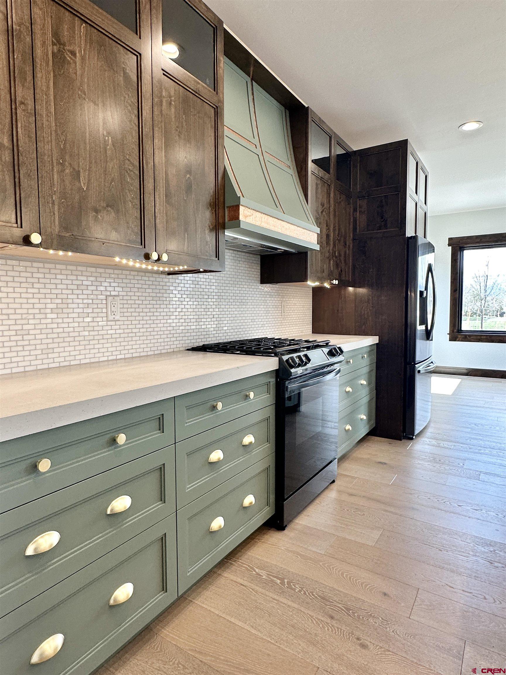 820 Southeast Pine Street Cedaredge, CO 81413 - Photo 14 of 35 a kitchen with stainless steel appliances granite countertop a stove a sink and a refrigerator