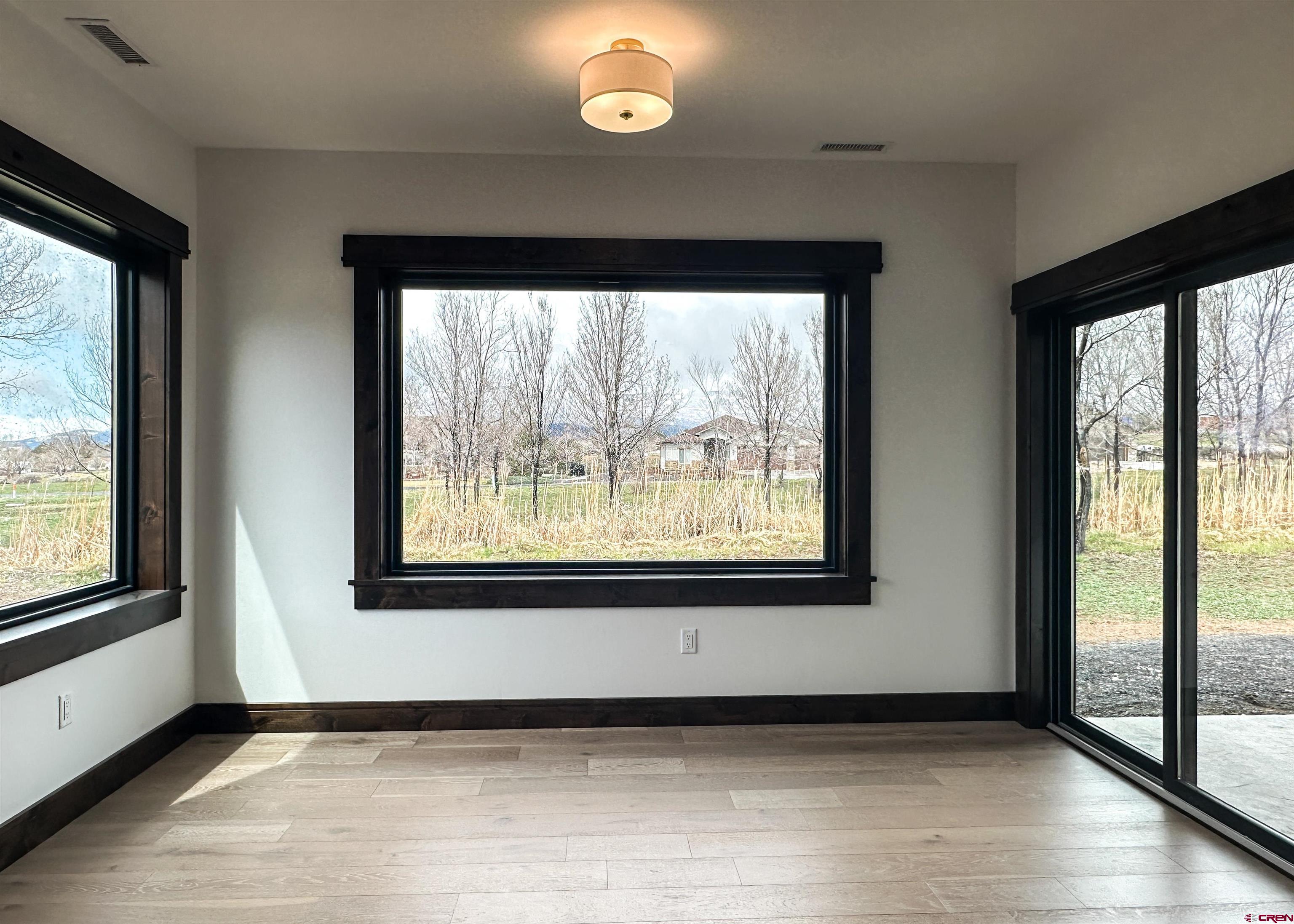 820 Southeast Pine Street Cedaredge, CO 81413 - Photo 15 of 35 a view of an empty room with wooden floor and a window