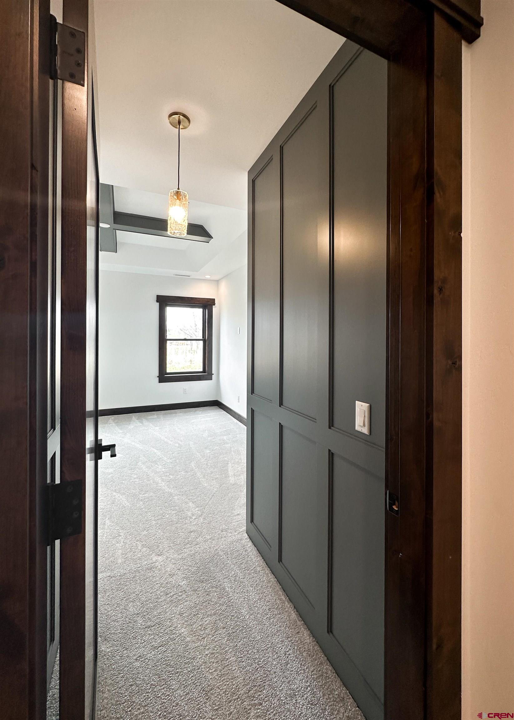 820 Southeast Pine Street Cedaredge, CO 81413 - Photo 18 of 35 a view of a refrigerator in kitchen and an empty room