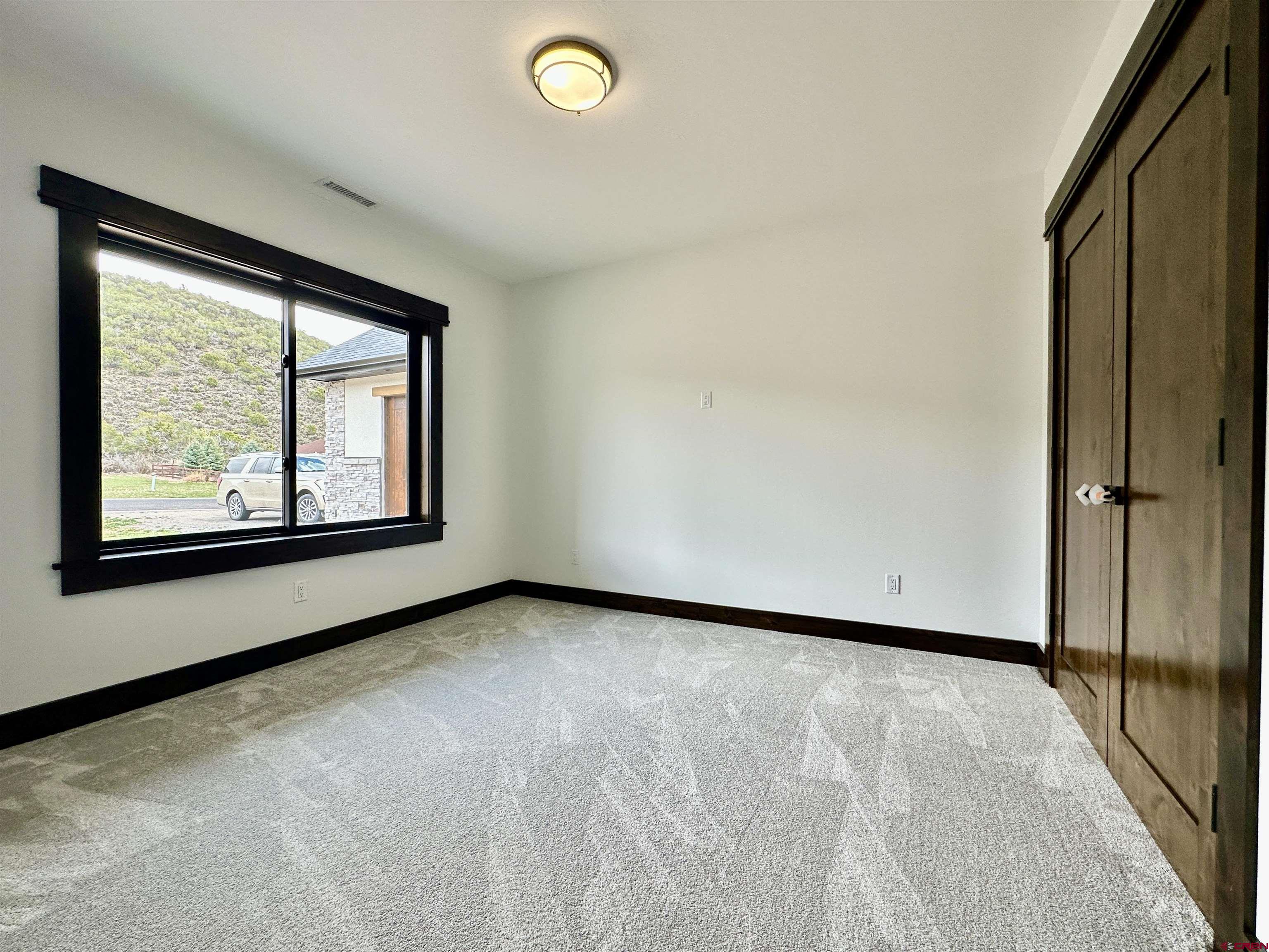 820 Southeast Pine Street Cedaredge, CO 81413 - Photo 23 of 35 a view of a room with wooden floor and window