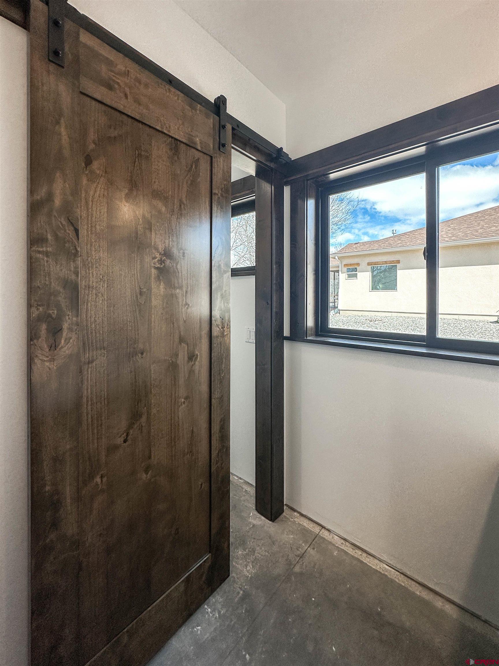 820 Southeast Pine Street Cedaredge, CO 81413 - Photo 26 of 35 a bathroom with a glass shower door