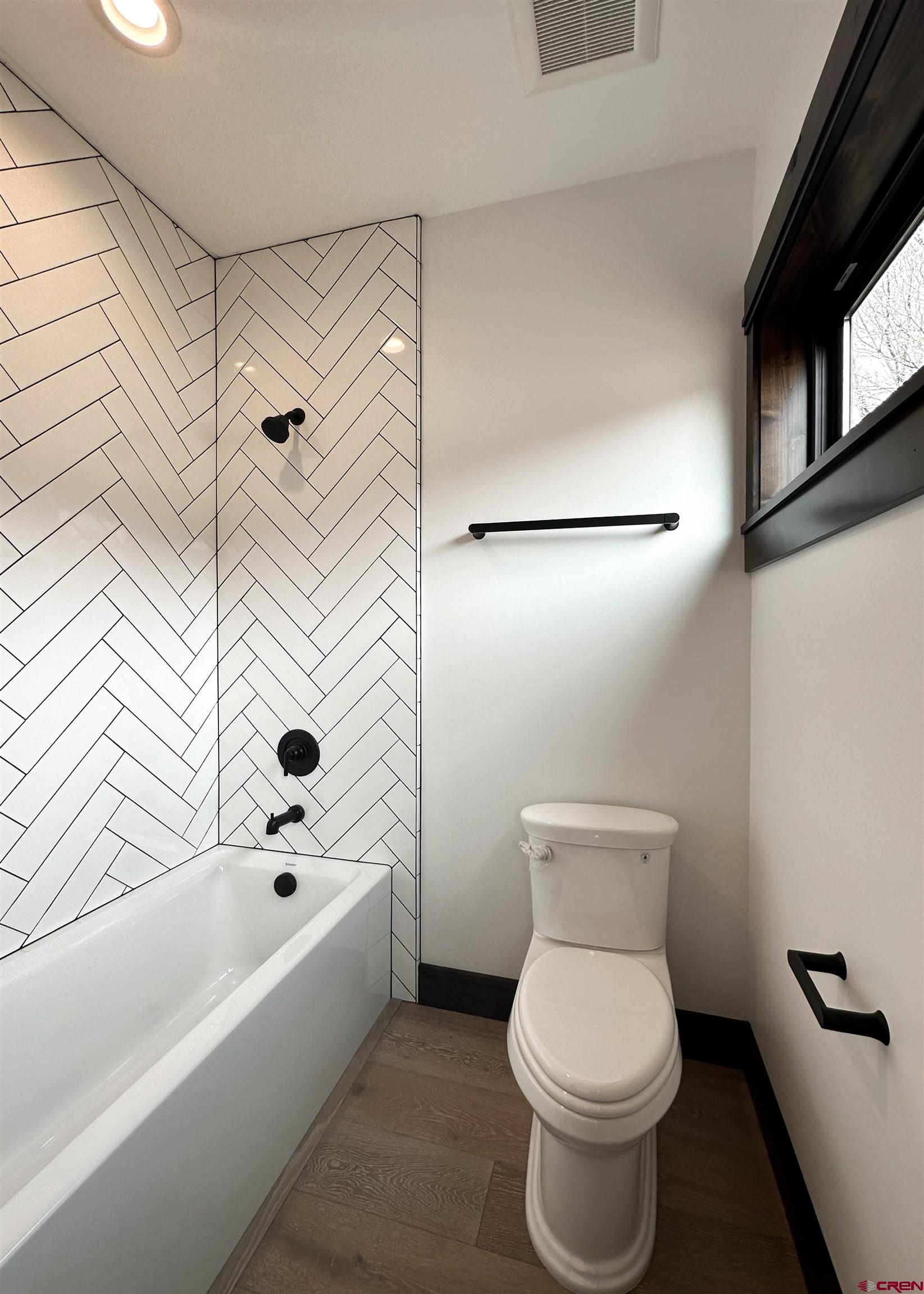 820 Southeast Pine Street Cedaredge, CO 81413 - Photo 27 of 35 a bathroom with a toilet and a bathtub