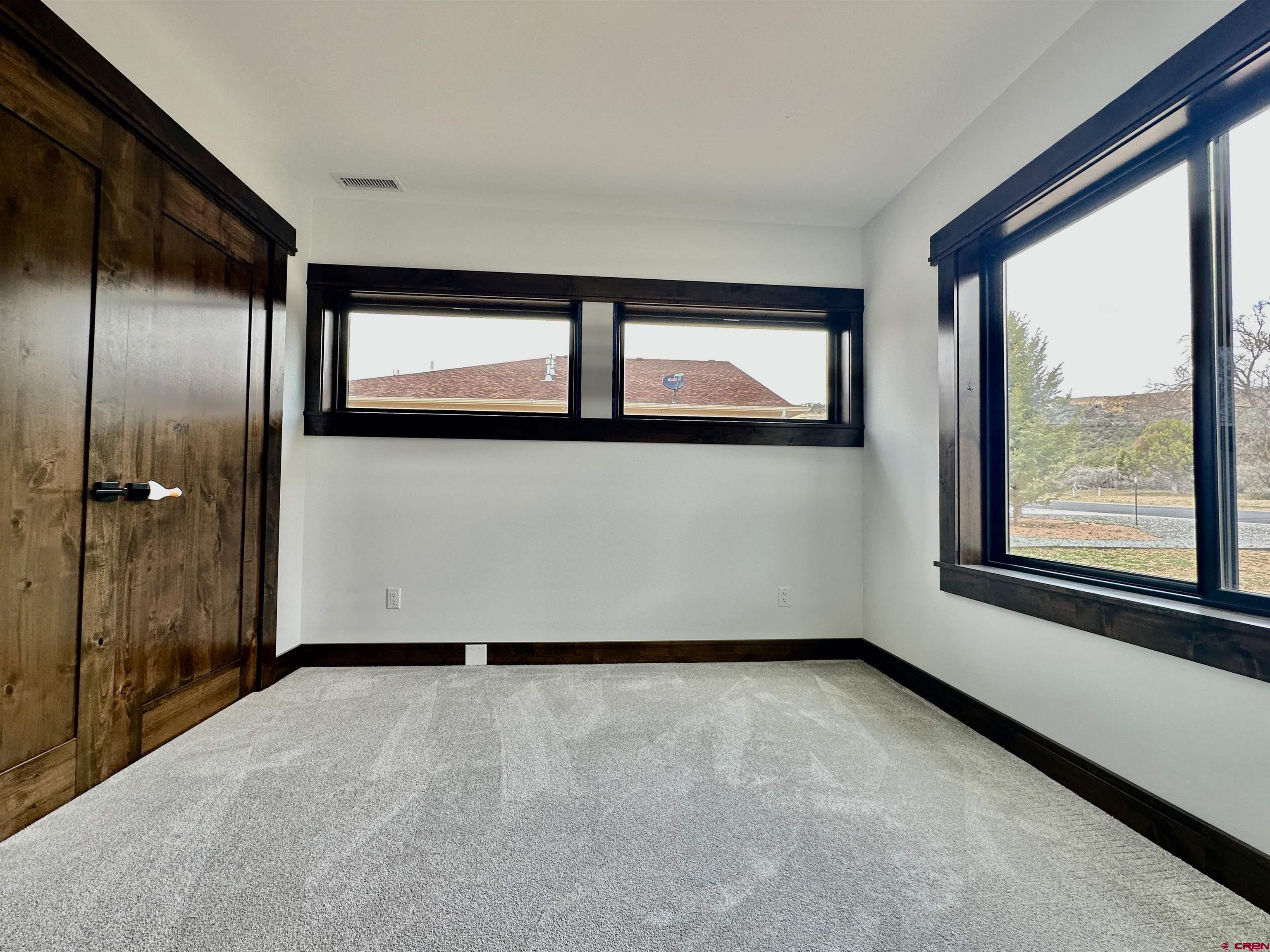 820 Southeast Pine Street Cedaredge, CO 81413 - Photo 28 of 35 a view of an empty room with a window