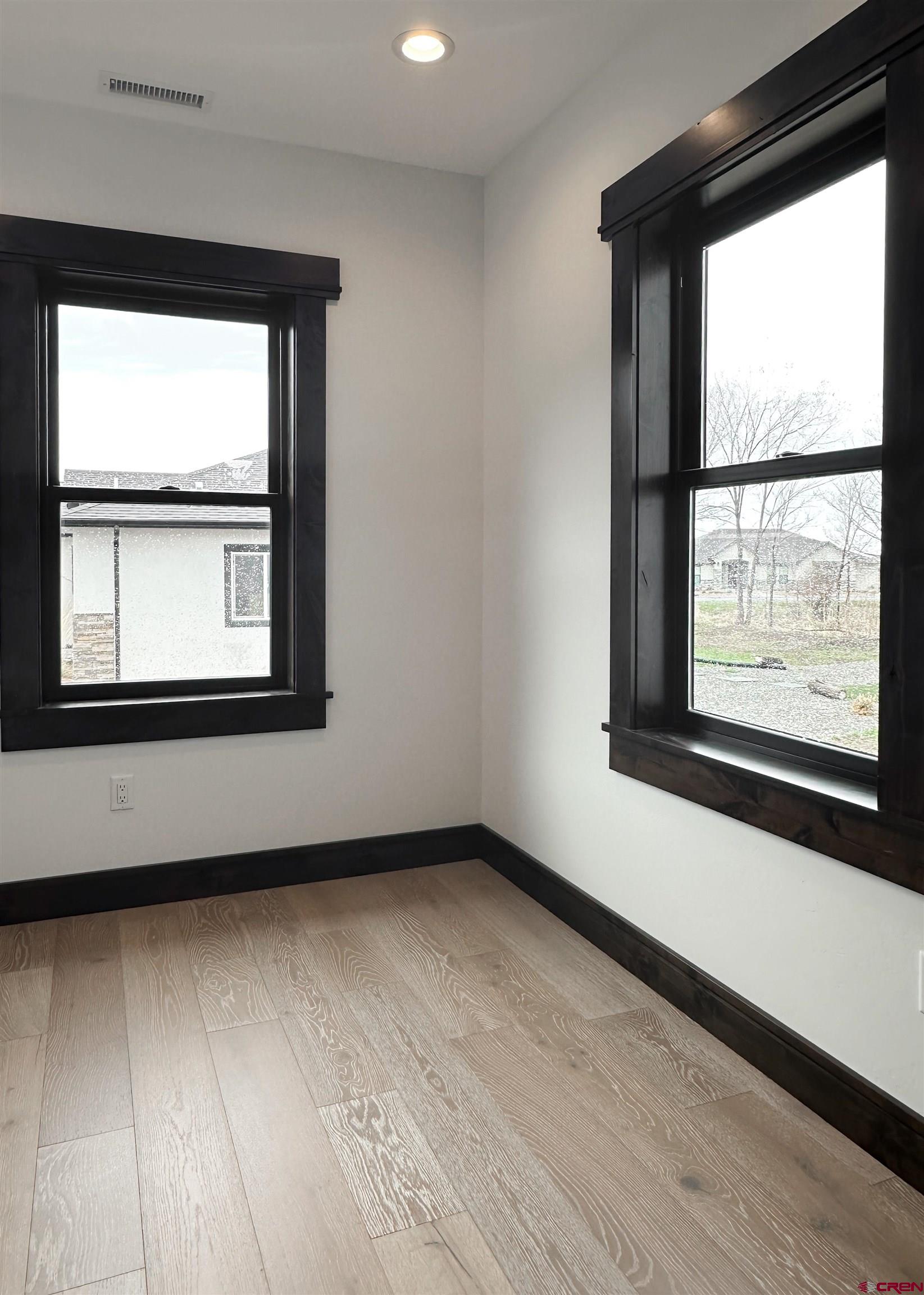 820 Southeast Pine Street Cedaredge, CO 81413 - Photo 30 of 35 an empty room with wooden floor and windows