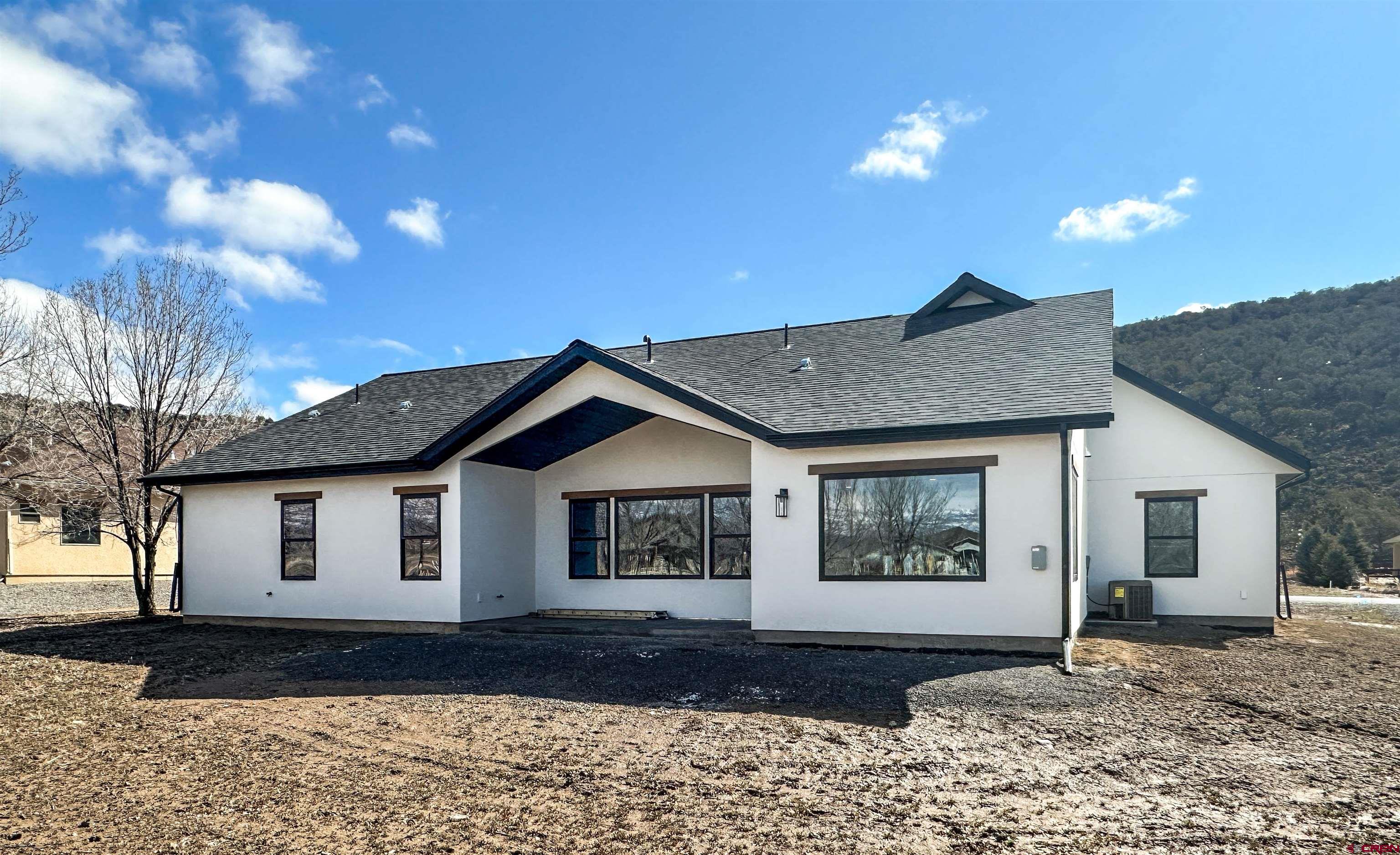 820 Southeast Pine Street Cedaredge, CO 81413 - Photo 34 of 35 a front view of a house with a yard