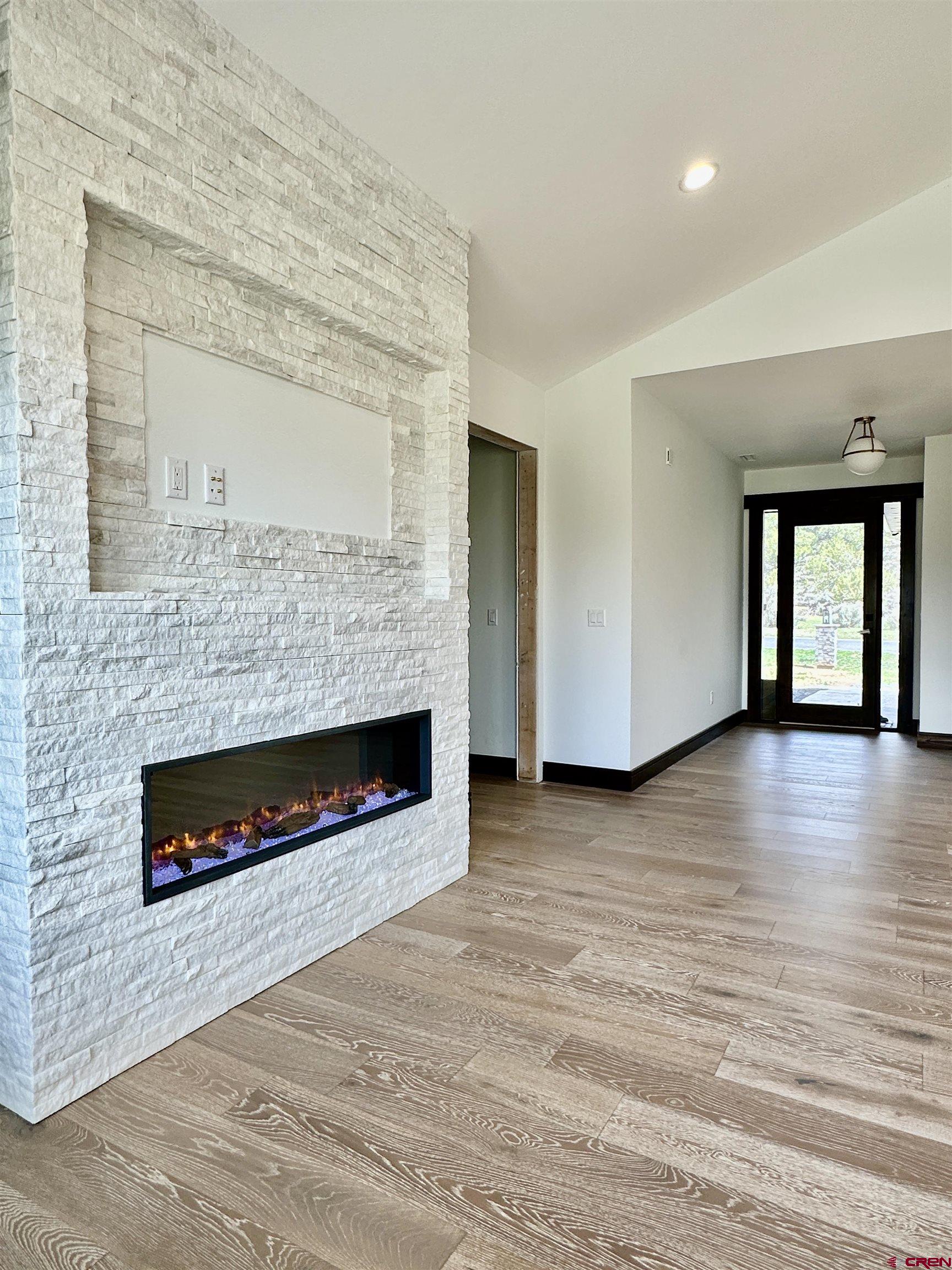 820 Southeast Pine Street Cedaredge, CO 81413 - Photo 8 of 35 an empty room with windows and fireplace
