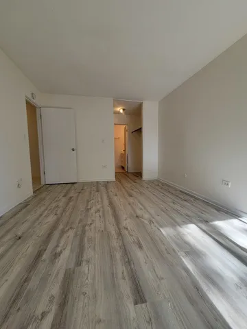 a view of an empty room and wooden floor