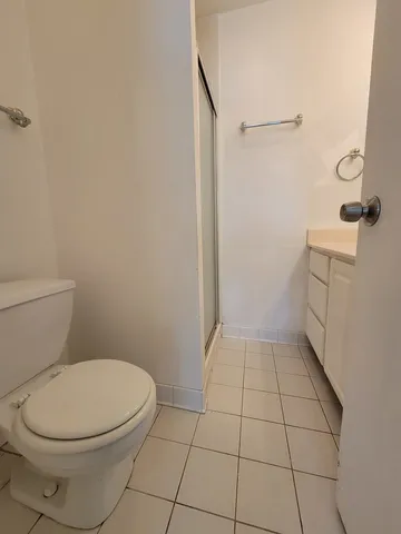 a bathroom with a toilet and a shower