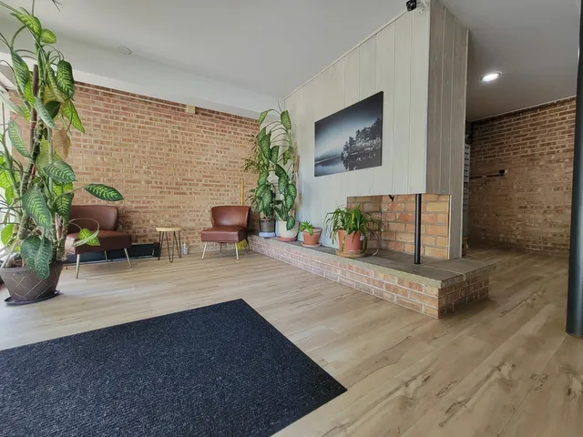 a view of living room filled with furniture and potted plant