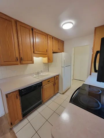 a kitchen with a sink and a refrigerator