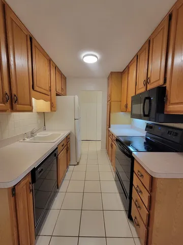 a kitchen with stainless steel appliances a sink stove and cabinets