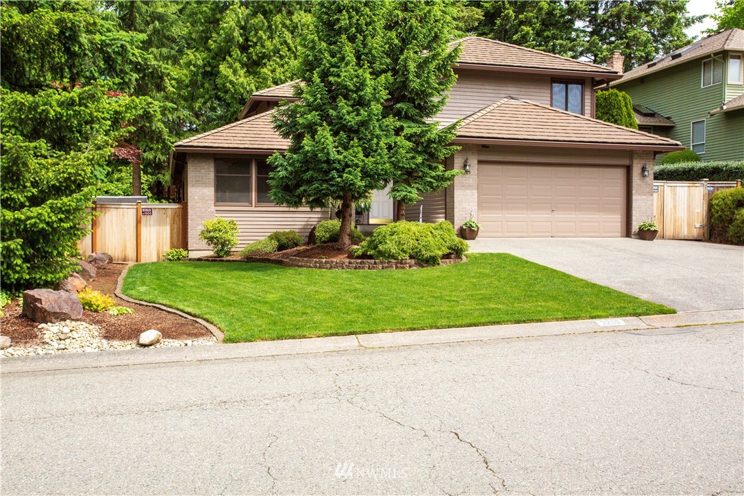 3205 211th Street Southeast Bothell, WA 98021 - Photo 1 of 40 a front view of a house with a yard and garage