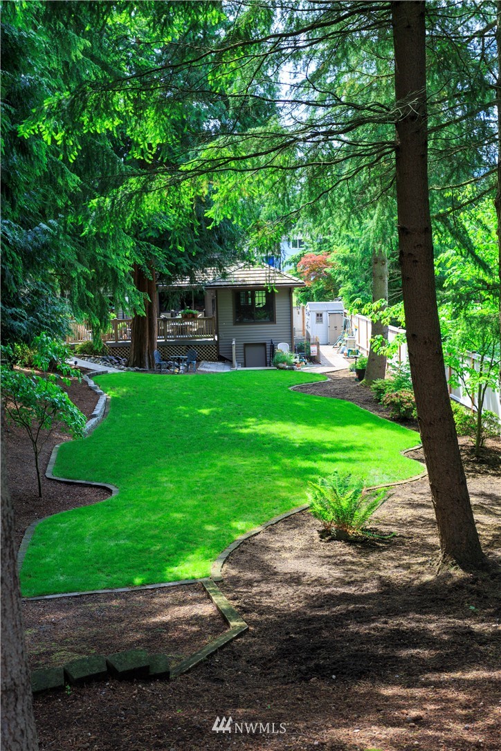 3205 211th Street Southeast Bothell, WA 98021 - Photo 36 of 40 a backyard of a house with a garden and outdoor seating