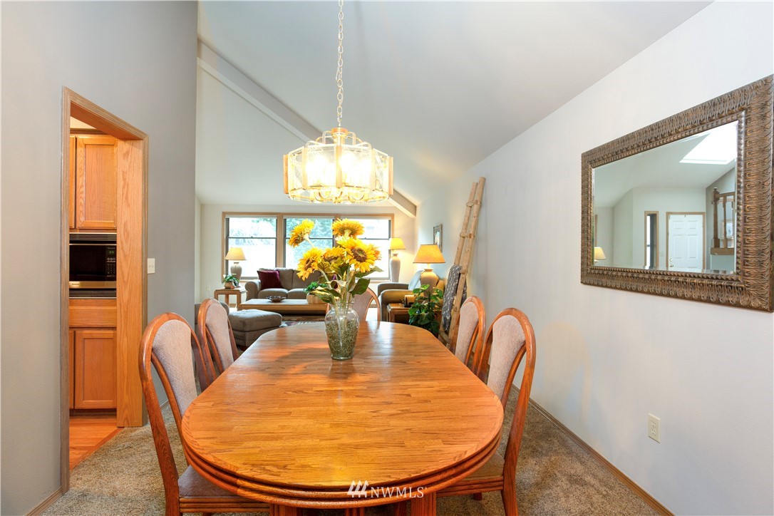 3205 211th Street Southeast Bothell, WA 98021 - Photo 7 of 40 a view of a dining room with furniture and chandelier