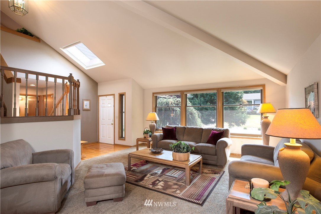 3205 211th Street Southeast Bothell, WA 98021 - Photo 8 of 40 a living room with furniture and a large window