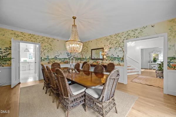 a kitchen with stainless steel appliances a stove a sink a center island and windows